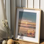 Picture frame mockup by a white wall on the wooden floor